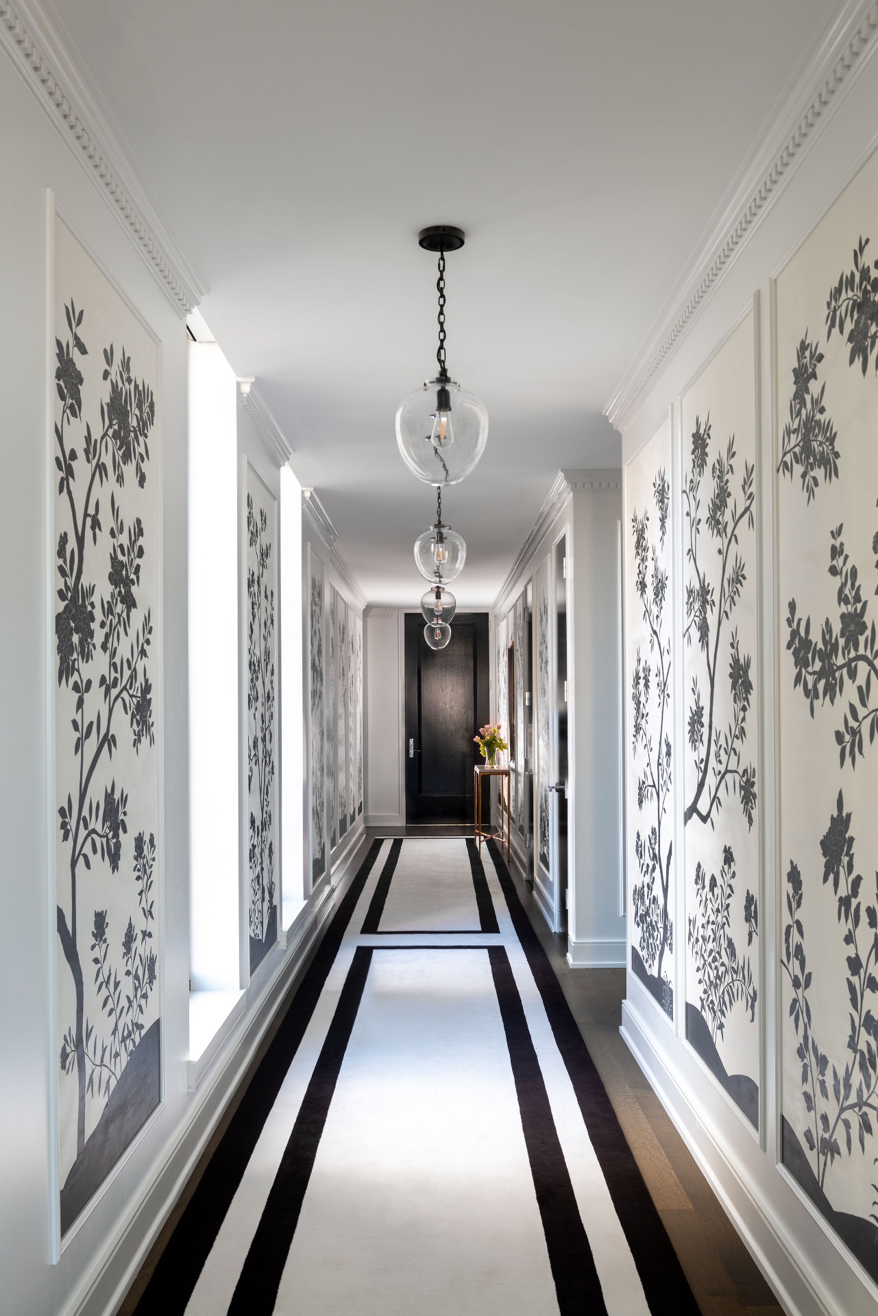 A long corridor of hand-painted panels at La Maison